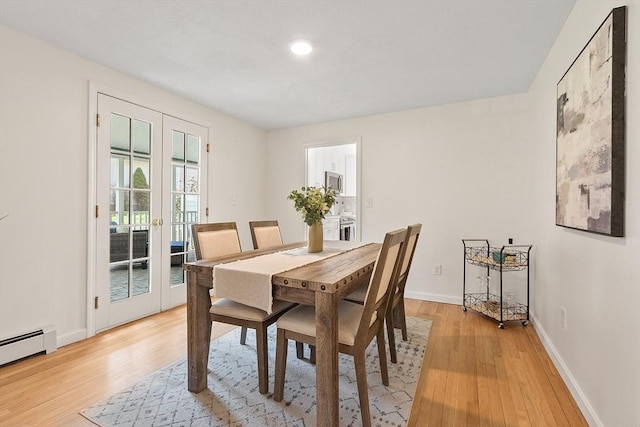 dining room featuring baseboards, recessed lighting, french doors, a baseboard radiator, and light wood finished floors