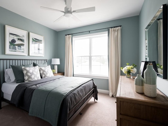 carpeted bedroom with baseboards and a ceiling fan