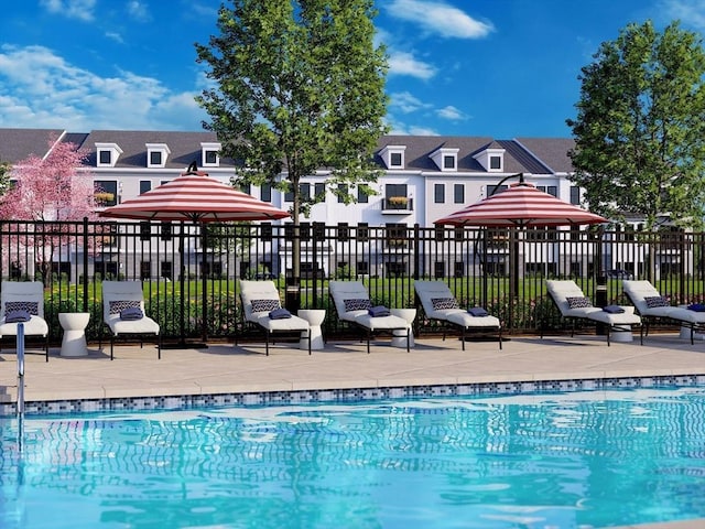 community pool with fence and a patio