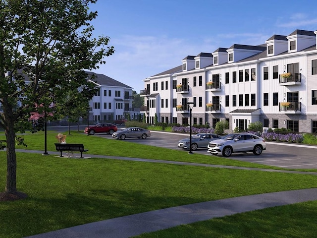 view of property with uncovered parking and a residential view