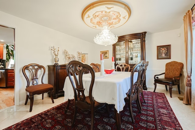 tiled dining room featuring a chandelier