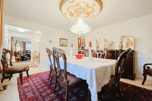 tiled dining space with an inviting chandelier