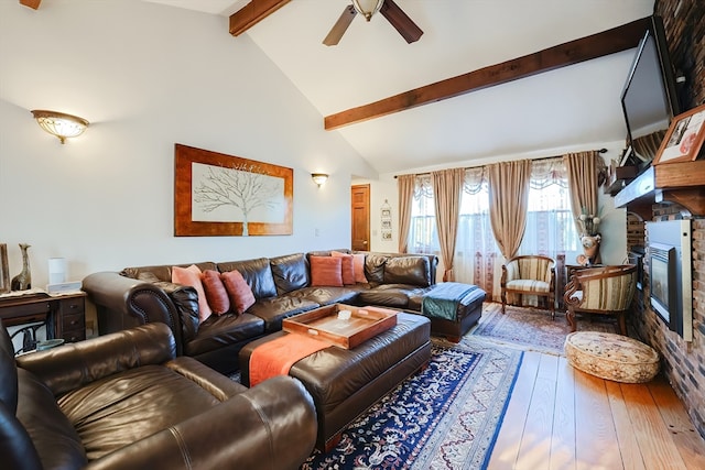 living room with high vaulted ceiling, a fireplace, ceiling fan, beam ceiling, and hardwood / wood-style flooring