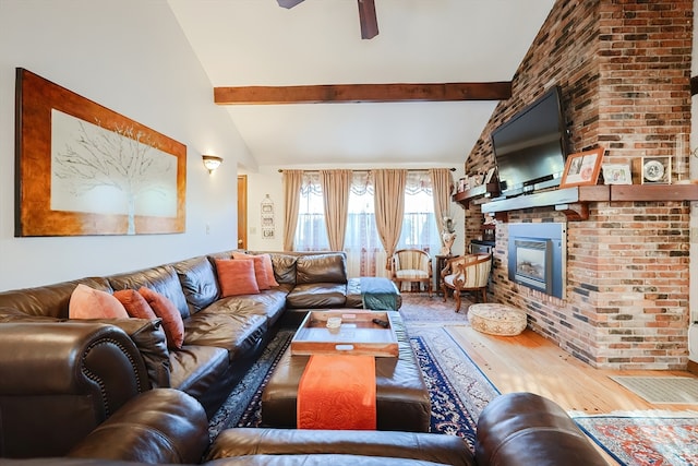 living room with lofted ceiling with beams, a fireplace, wood-type flooring, and ceiling fan