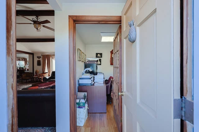 hall with beam ceiling and light hardwood / wood-style flooring