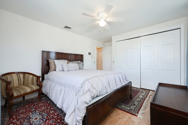 bedroom with a closet, ceiling fan, and wood-type flooring