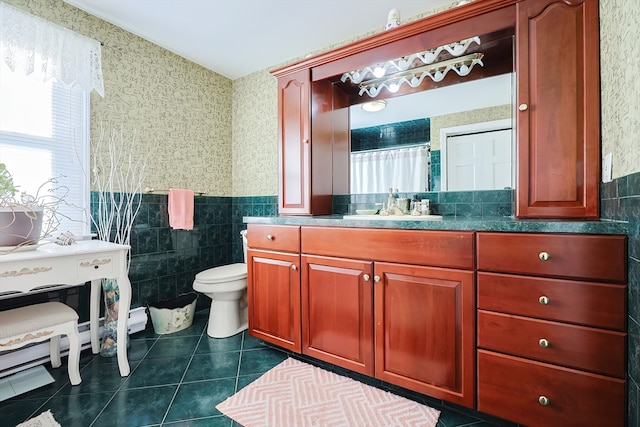 bathroom with vanity, toilet, tile walls, and tile patterned flooring