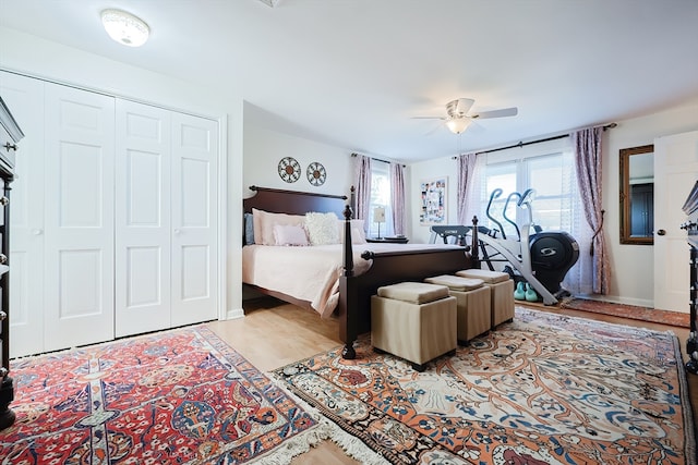 bedroom featuring light hardwood / wood-style floors, a closet, and ceiling fan