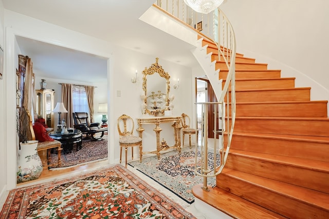 stairway with wood-type flooring and a wealth of natural light