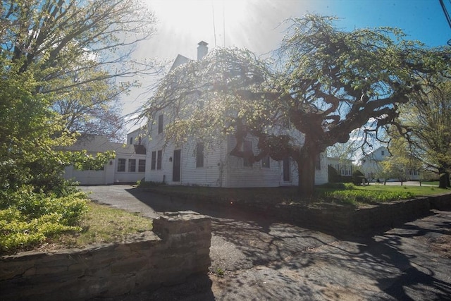 view of property exterior featuring a chimney