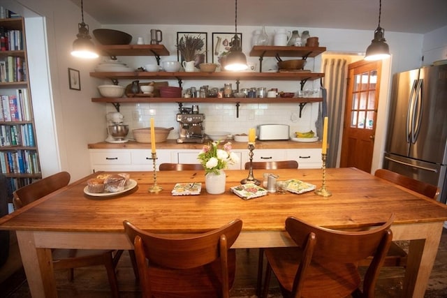 kitchen featuring open shelves, freestanding refrigerator, and backsplash