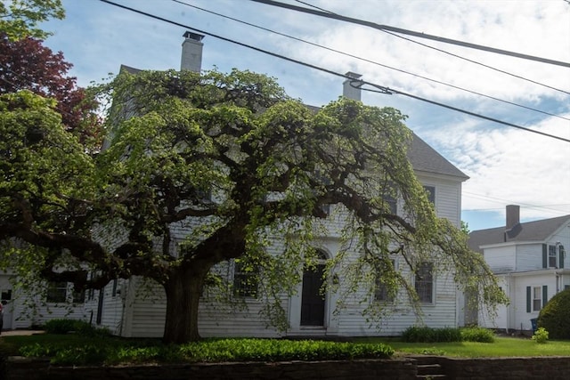 view of property exterior featuring a chimney