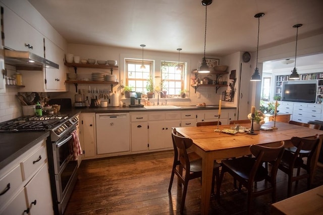 kitchen featuring open shelves, white dishwasher, range with two ovens, a sink, and under cabinet range hood
