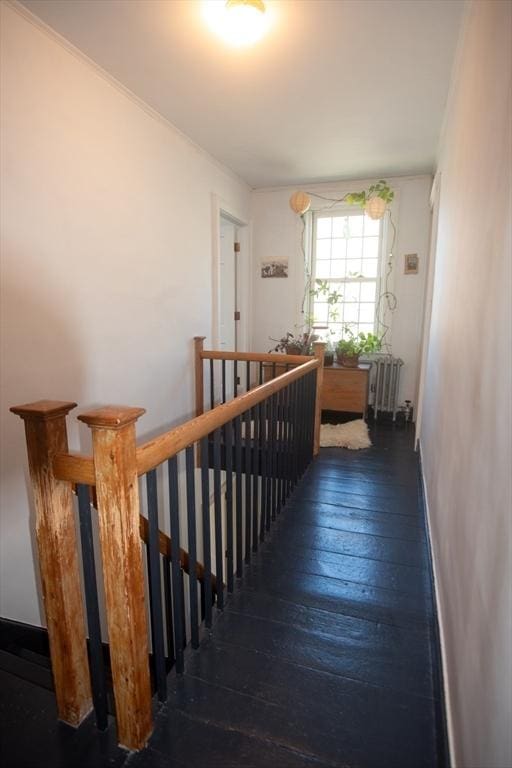 stairway with radiator heating unit and hardwood / wood-style flooring
