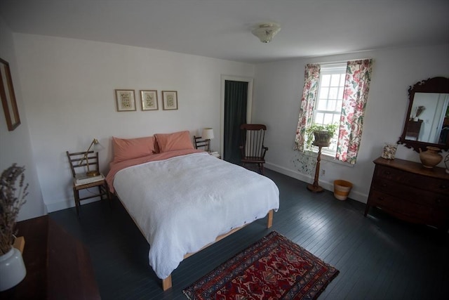 bedroom with hardwood / wood-style floors and baseboards