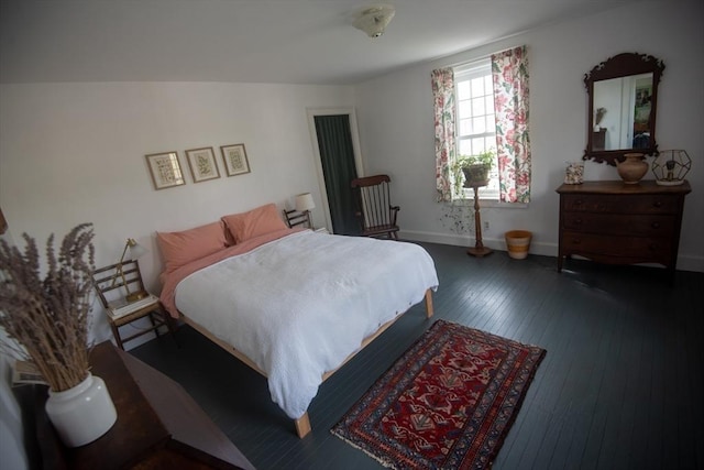 bedroom featuring wood-type flooring and baseboards