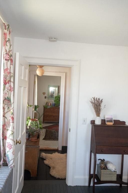 doorway featuring baseboards