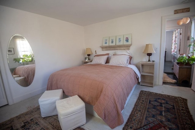 carpeted bedroom featuring baseboards