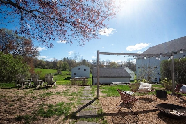 view of yard with an outdoor fire pit
