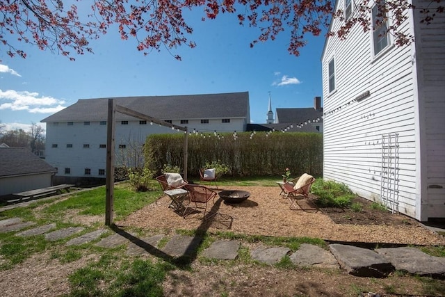view of yard with an outdoor fire pit