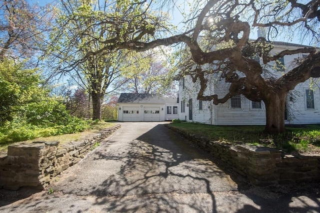 view of home's exterior with driveway and a garage