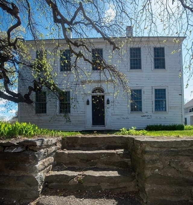 colonial home featuring a chimney