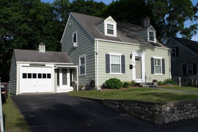 24 Garey St, Weymouth, MA 02189 - new england style home with an attached garage, driveway, a chimney, a front yard, and cooling unit