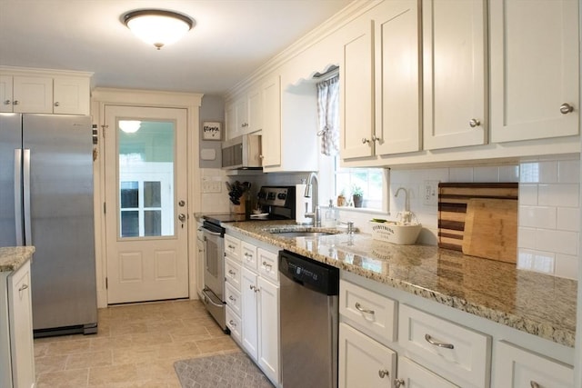 24 Garey St, Weymouth, MA 02189 - kitchen featuring appliances with stainless steel finishes, white cabinets, decorative backsplash, and light stone counters