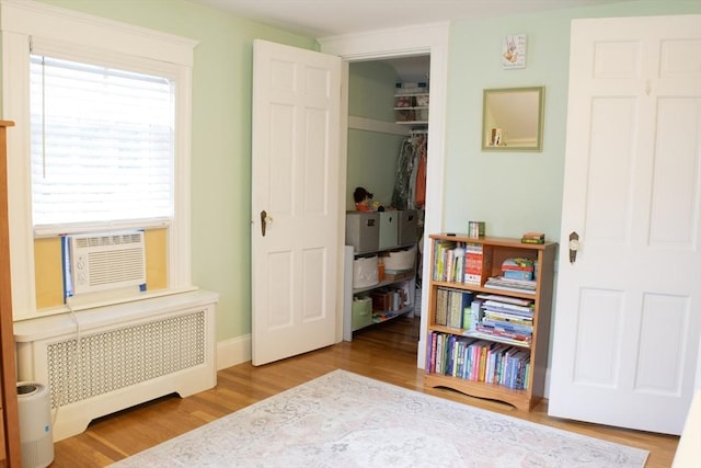 24 Garey St, Weymouth, MA 02189 - bedroom with radiator, wood finished floors, a spacious closet, a closet, and cooling unit