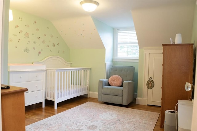 24 Garey St, Weymouth, MA 02189 - bedroom featuring wood finished floors, a nursery area, and vaulted ceiling