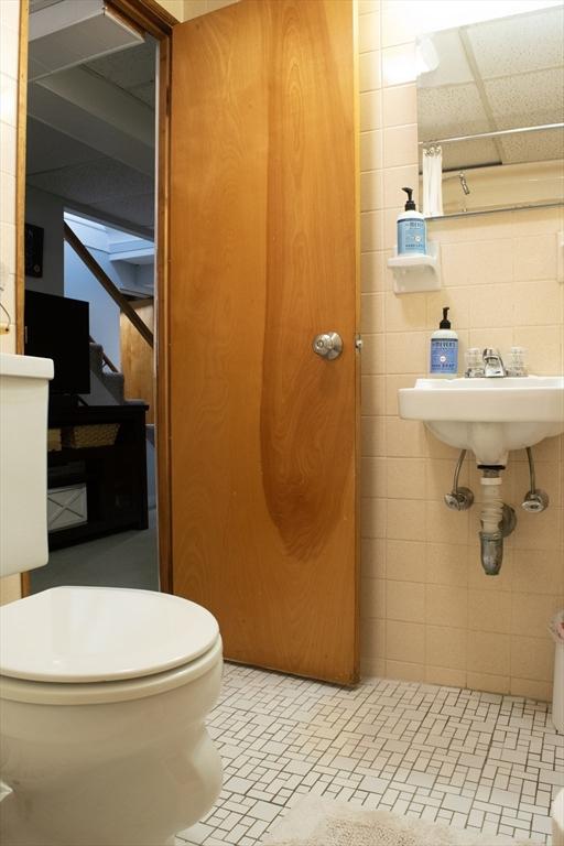 24 Garey St, Weymouth, MA 02189 - bathroom featuring curtained shower and tile walls