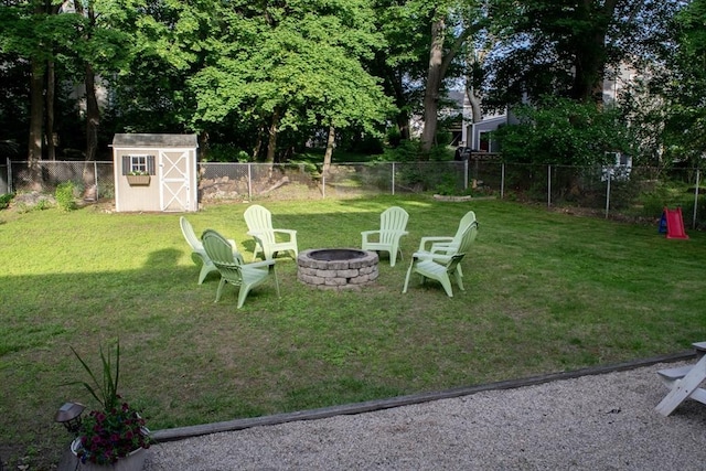 24 Garey St, Weymouth, MA 02189 - fenced backyard featuring an outdoor fire pit and a storage shed