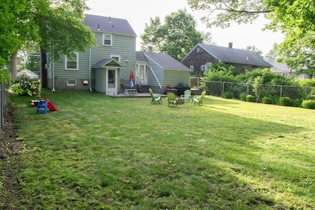 24 Garey St, Weymouth, MA 02189 - rear view of house featuring a fenced backyard, a patio area, and an outdoor fire pit
