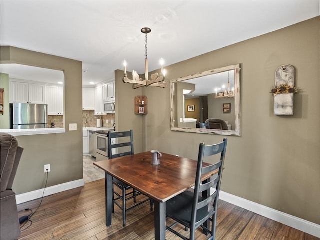 770 Salisbury Unit 302, Worcester, MA 01609 - dining area with a chandelier and wood finished floors