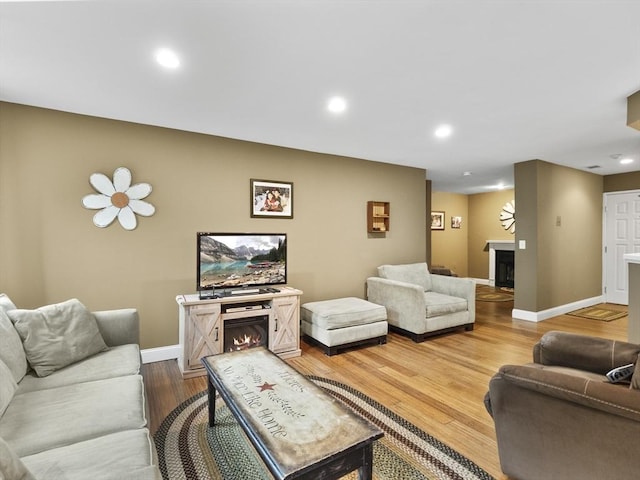 770 Salisbury Unit 302, Worcester, MA 01609 - living area with a warm lit fireplace, wood finished floors, and recessed lighting