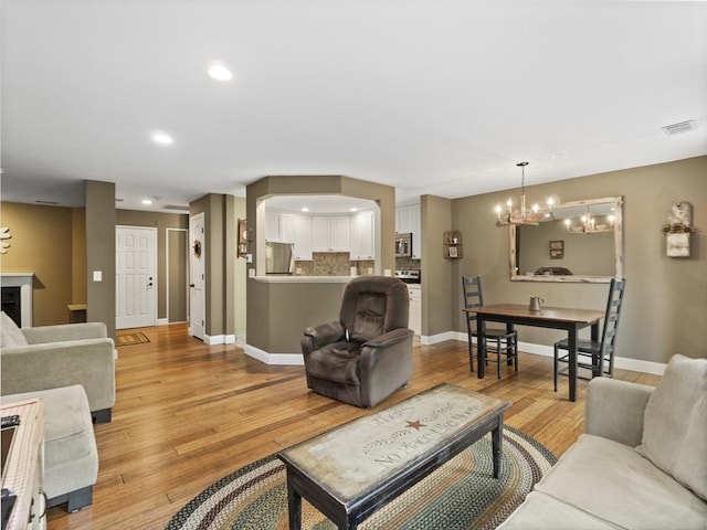 770 Salisbury Unit 302, Worcester, MA 01609 - living room with a chandelier, light wood finished floors, and recessed lighting