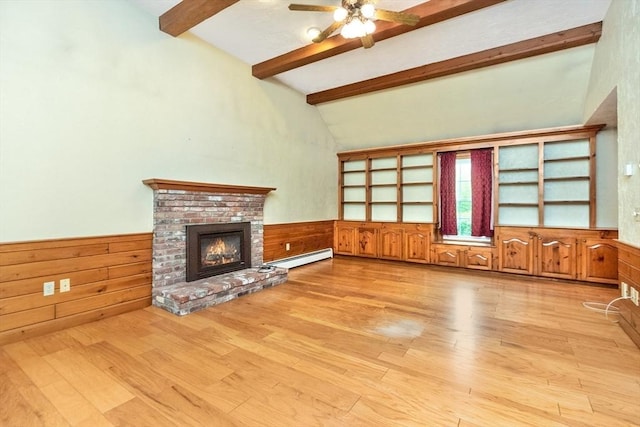 10 Eagle Rd, Winchendon, MA 01475 - unfurnished living room with beam ceiling, a baseboard heating unit, a fireplace, wainscoting, and wood finished floors