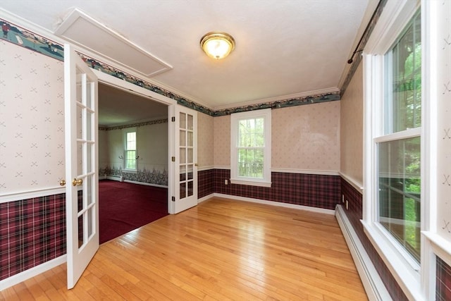 10 Eagle Rd, Winchendon, MA 01475 - unfurnished room featuring french doors, a wainscoted wall, wallpapered walls, hardwood / wood-style flooring, and attic access