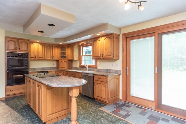 10 Eagle Rd, Winchendon, MA 01475 - kitchen with black appliances, a sink, a center island, brown cabinets, and light stone counters