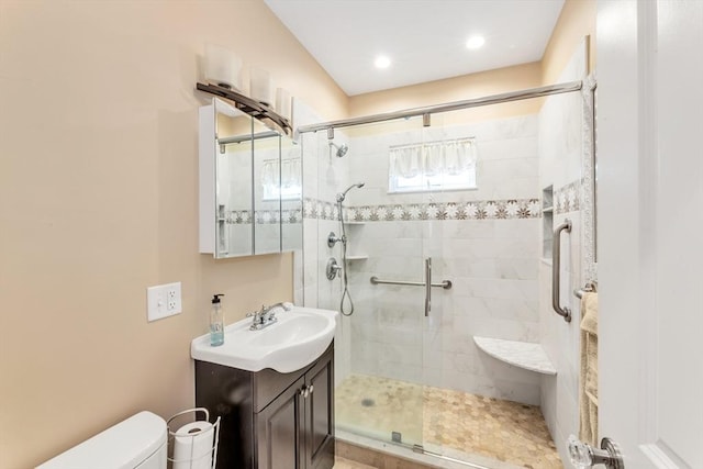 full bathroom with vanity, a stall shower, and toilet