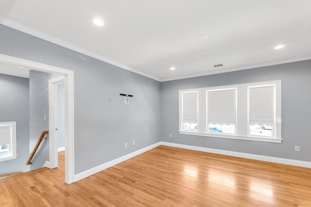 empty room featuring crown molding, visible vents, baseboards, recessed lighting, and light wood-type flooring