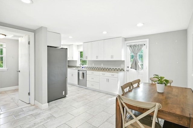 606 Granby Rd, South Hadley, MA 01075 - kitchen featuring appliances with stainless steel finishes, light countertops, healthy amount of natural light, white cabinetry, and recessed lighting