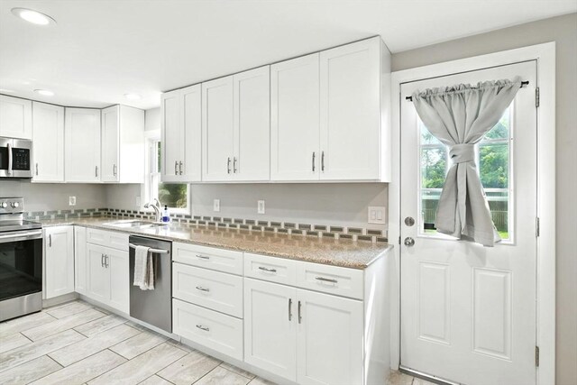 606 Granby Rd, South Hadley, MA 01075 - kitchen featuring appliances with stainless steel finishes, recessed lighting, white cabinets, wood tiled floors, and light stone countertops