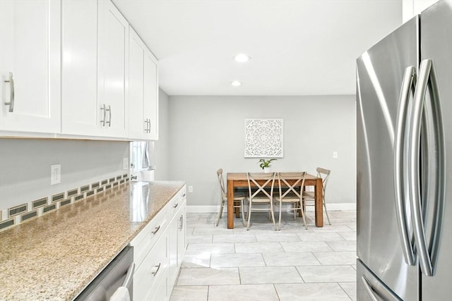 606 Granby Rd, South Hadley, MA 01075 - kitchen with freestanding refrigerator, recessed lighting, light stone counters, and white cabinets