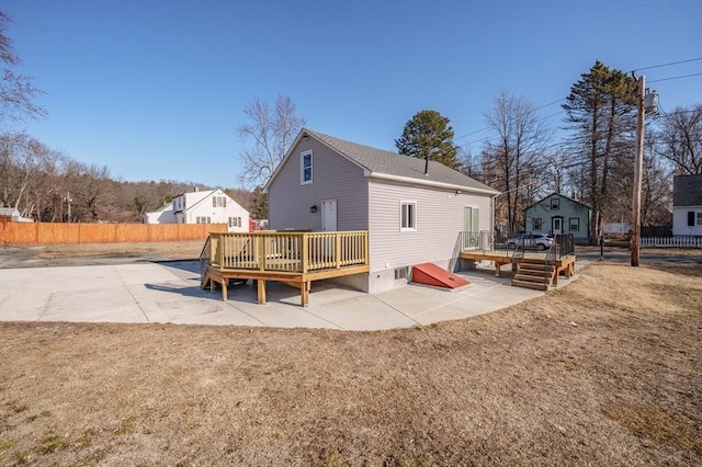 back of house with a wooden deck, a patio area, and fence