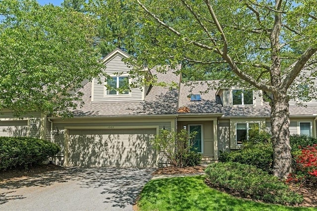 1003 Wisteria Way Unit 1003, Wayland, MA 01778 - view of front of property featuring a garage, concrete driveway, and roof with shingles