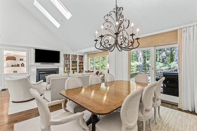 1003 Wisteria Way Unit 1003, Wayland, MA 01778 - dining space with high vaulted ceiling, built in features, a glass covered fireplace, wood finished floors, and a skylight