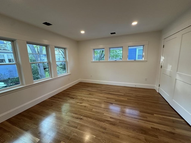 2 Wilkins Pl, Boston, MA 02131 - unfurnished bedroom with baseboards, wood finished floors, and recessed lighting
