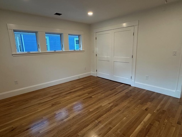 2 Wilkins Pl, Boston, MA 02131 - unfurnished bedroom featuring baseboards, wood finished floors, recessed lighting, and a closet