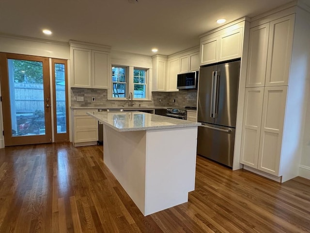 2 Wilkins Pl, Boston, MA 02131 - kitchen featuring stainless steel appliances, white cabinets, dark wood finished floors, decorative backsplash, and recessed lighting